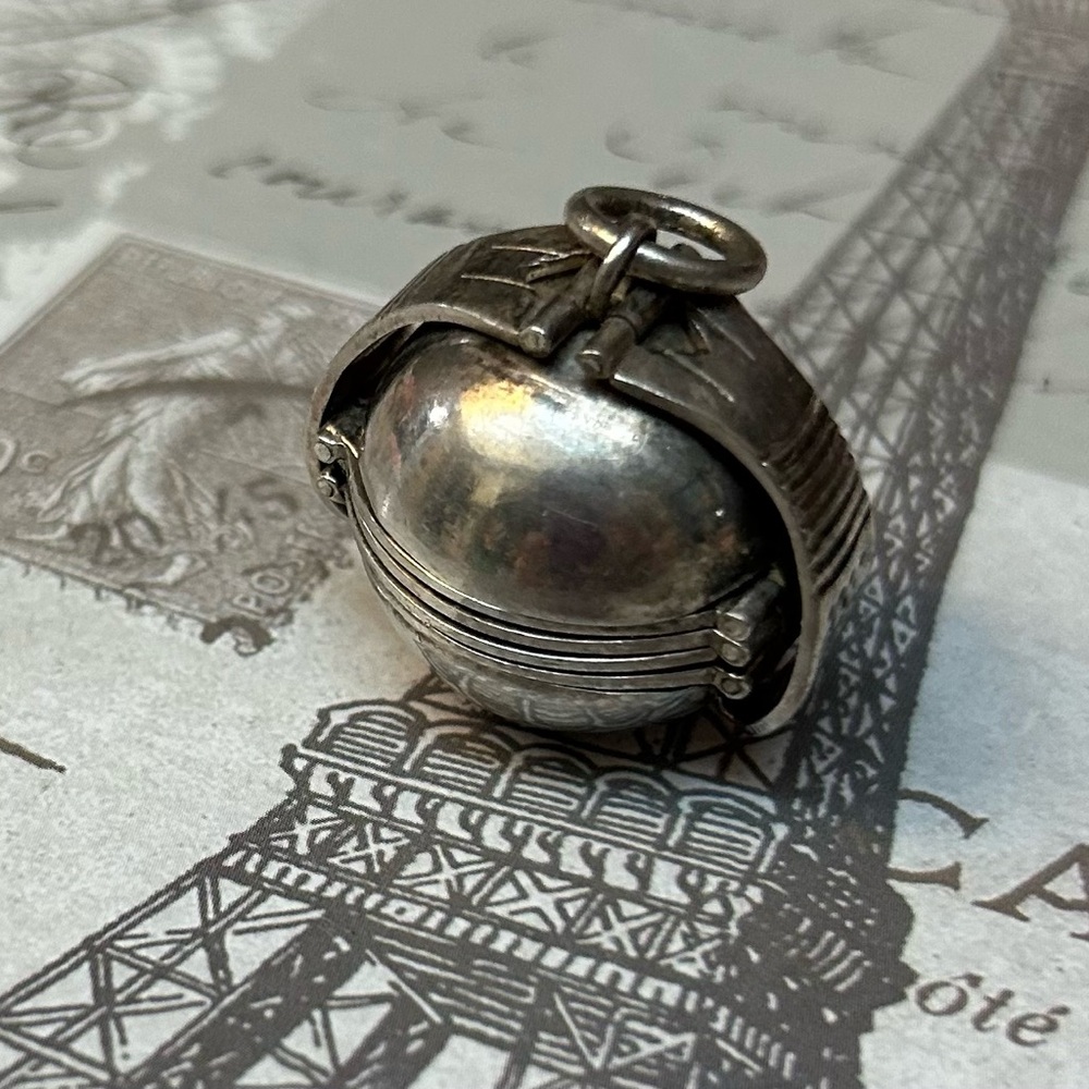 Antique Sterling Silver Ball locket unrolls to reveal several picture frames